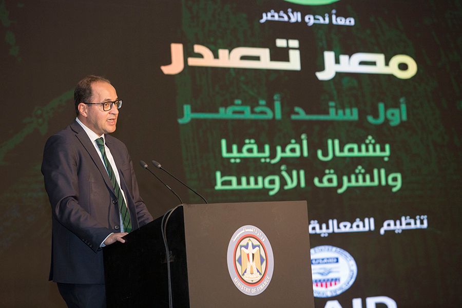 A photo of a man speaking behind a podium