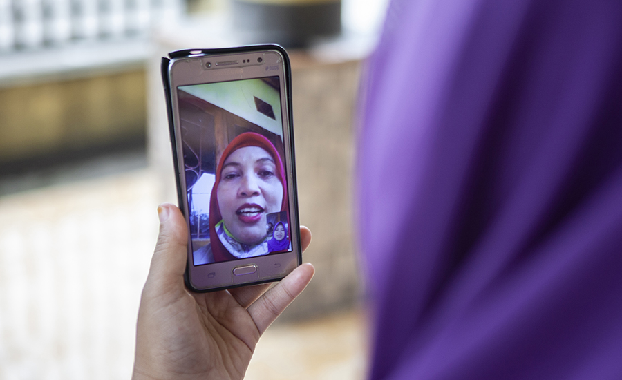A photo of a woman having a video call on her phone