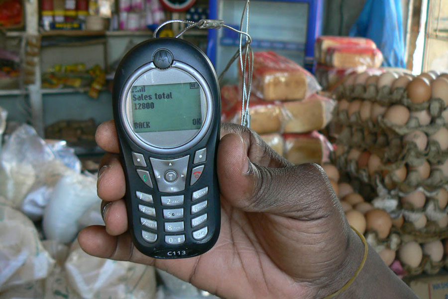 Photo of a mobile phone displaying a sales receipt.